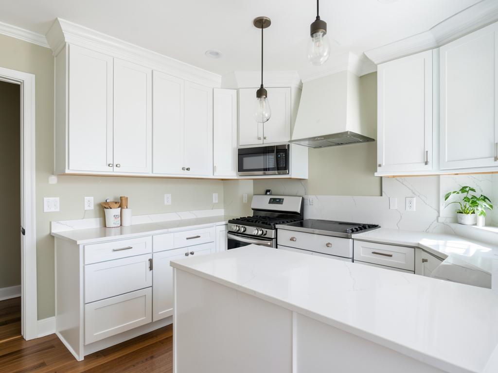 Remodeled kitchen with white cabinets and new countertops